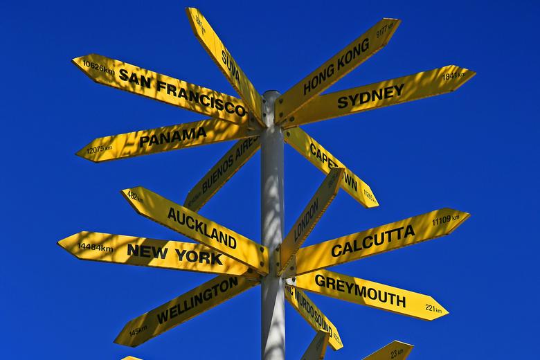 Yellow signposts pointing in many different directions