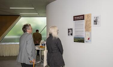 two people looking at posters on the wall