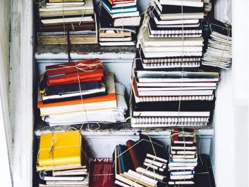 Image of stacked books and notebooks