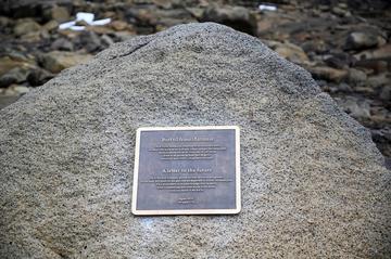 Bronze plaque on a rock within a rocky landscape