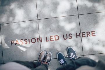 Image depicting a photograph of outdoor paving slabs with the written words 'Passion led us here'. 