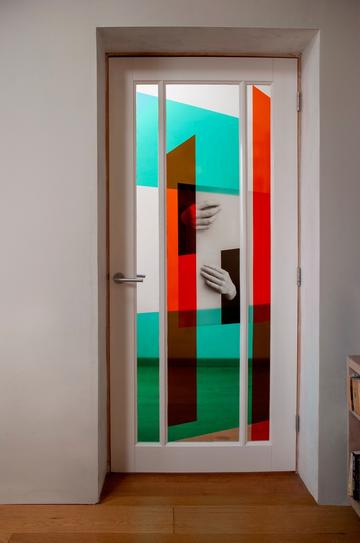 Door with three panels, showing 2 hands. Colour blocks of red and blue