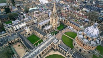 Aerial view of Oxford depicting colleges and green lawns