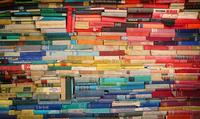 pile of books ranged by rainbow colours